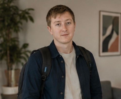 Moritz Zinecker standing in an indoor work setting