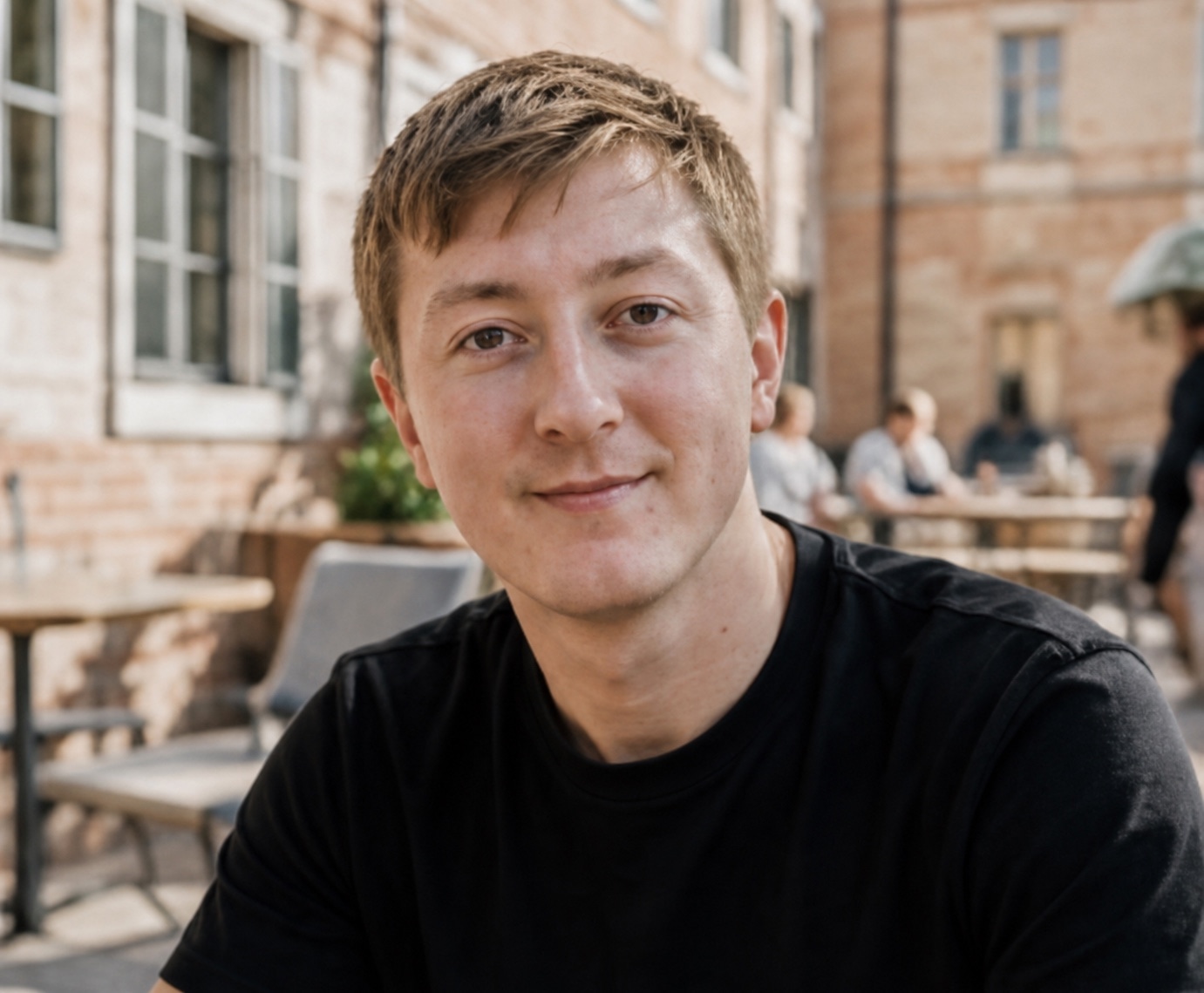 Moritz Zinecker seated in an outdoor café setting