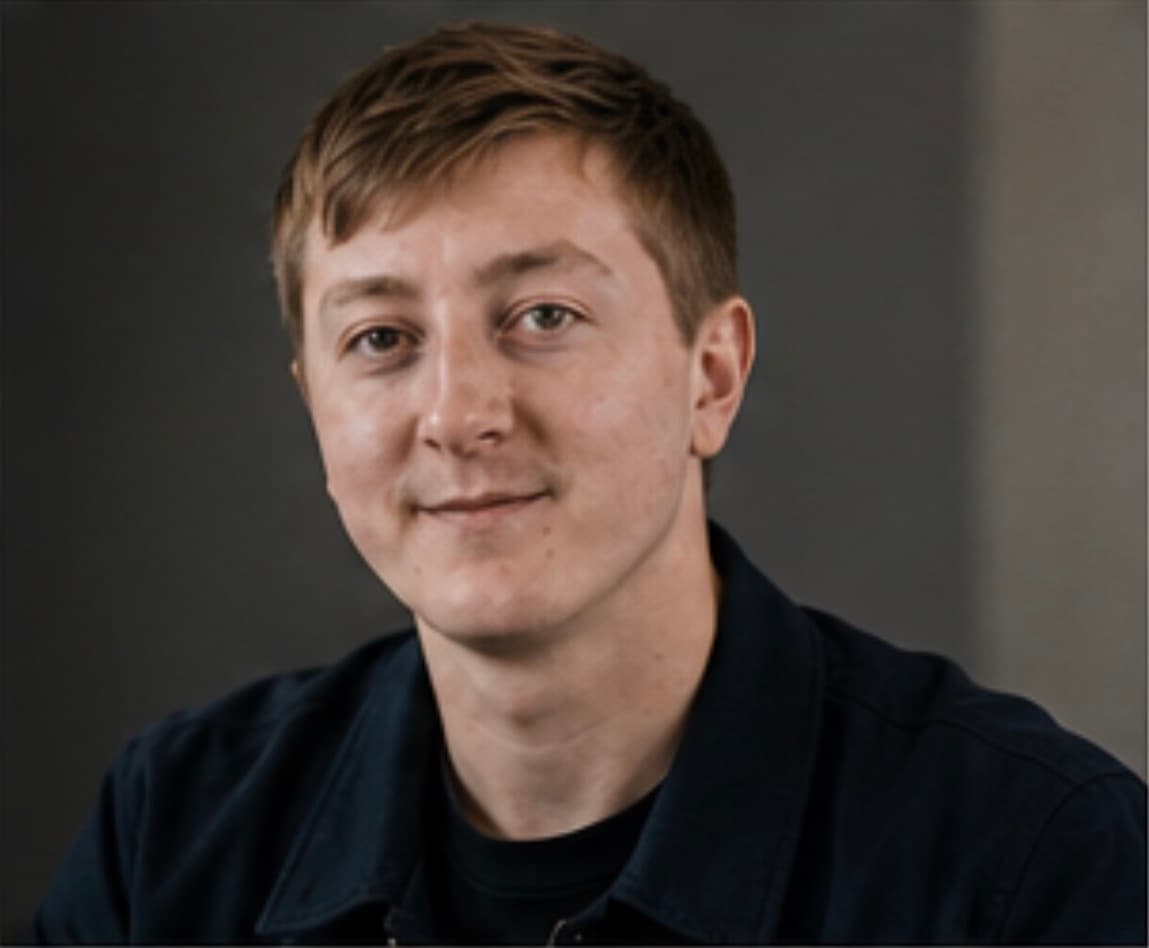 Close editorial portrait of Moritz Zinecker against a neutral background