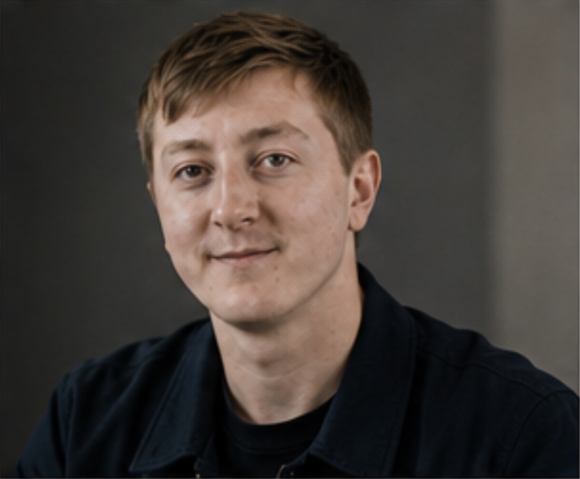Close editorial portrait of Moritz Zinecker against a neutral background