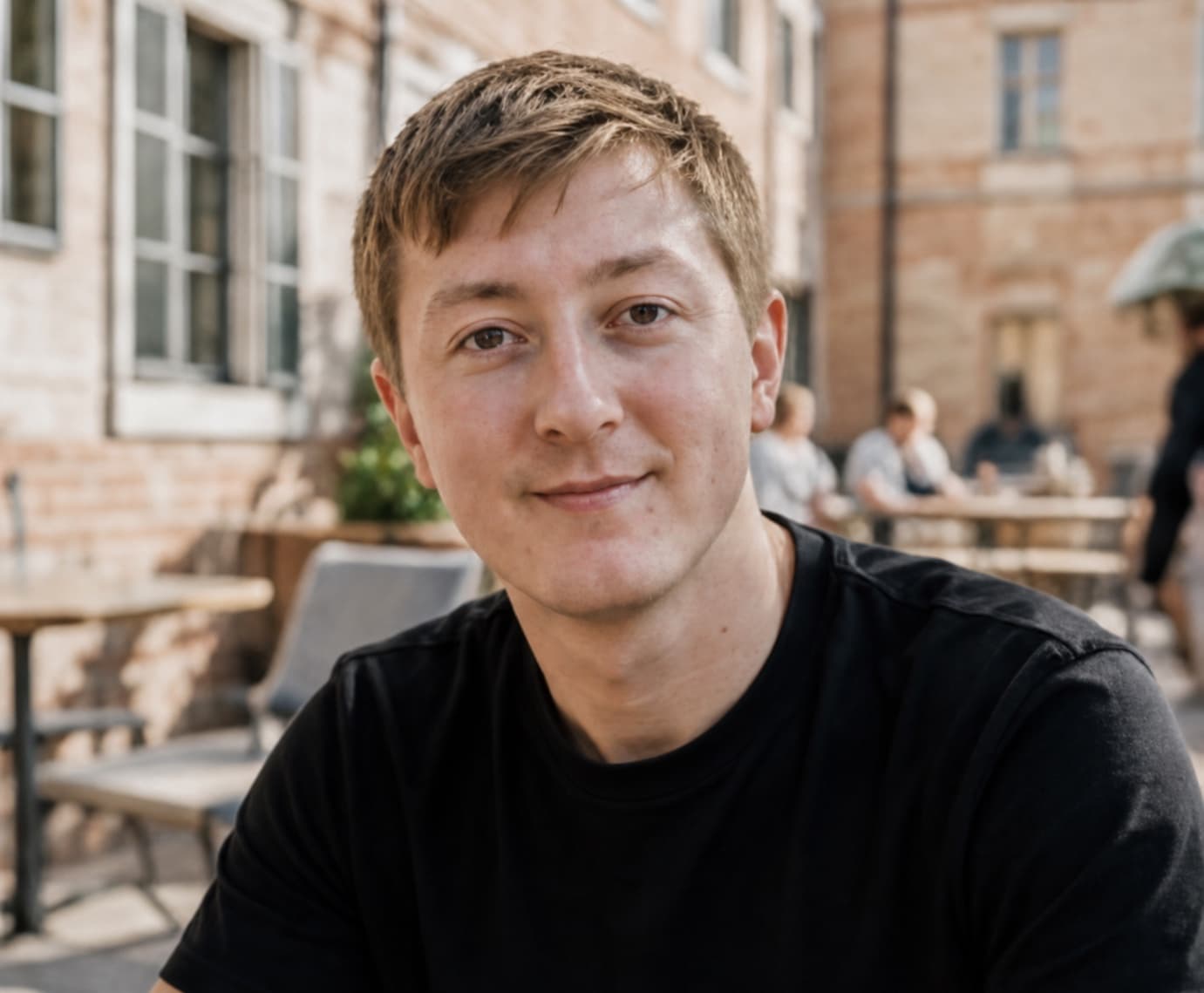 Moritz Zinecker seated in an outdoor café setting